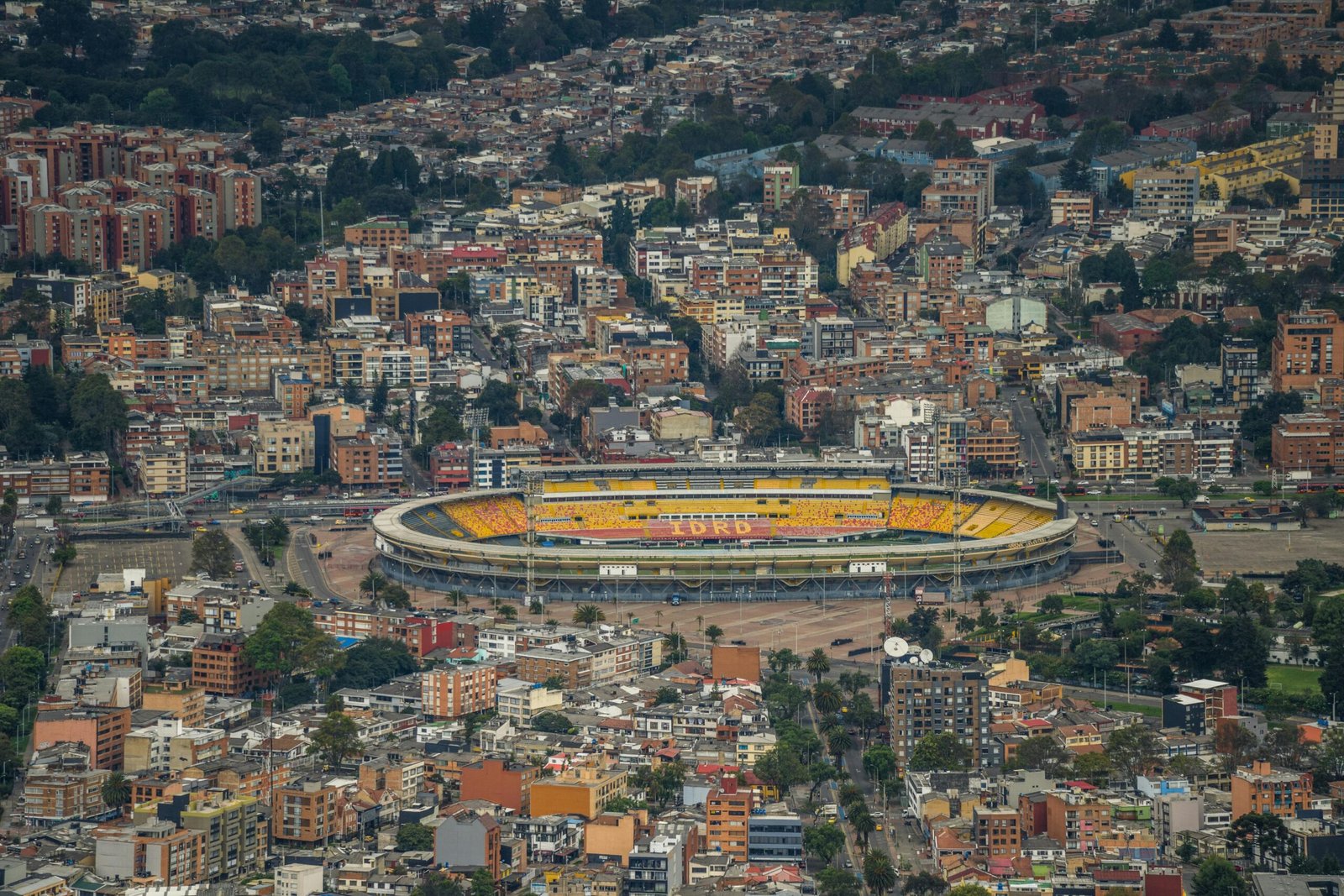 Aerial view of Bogotá's urban landscape featuring Estadio El Campín.
